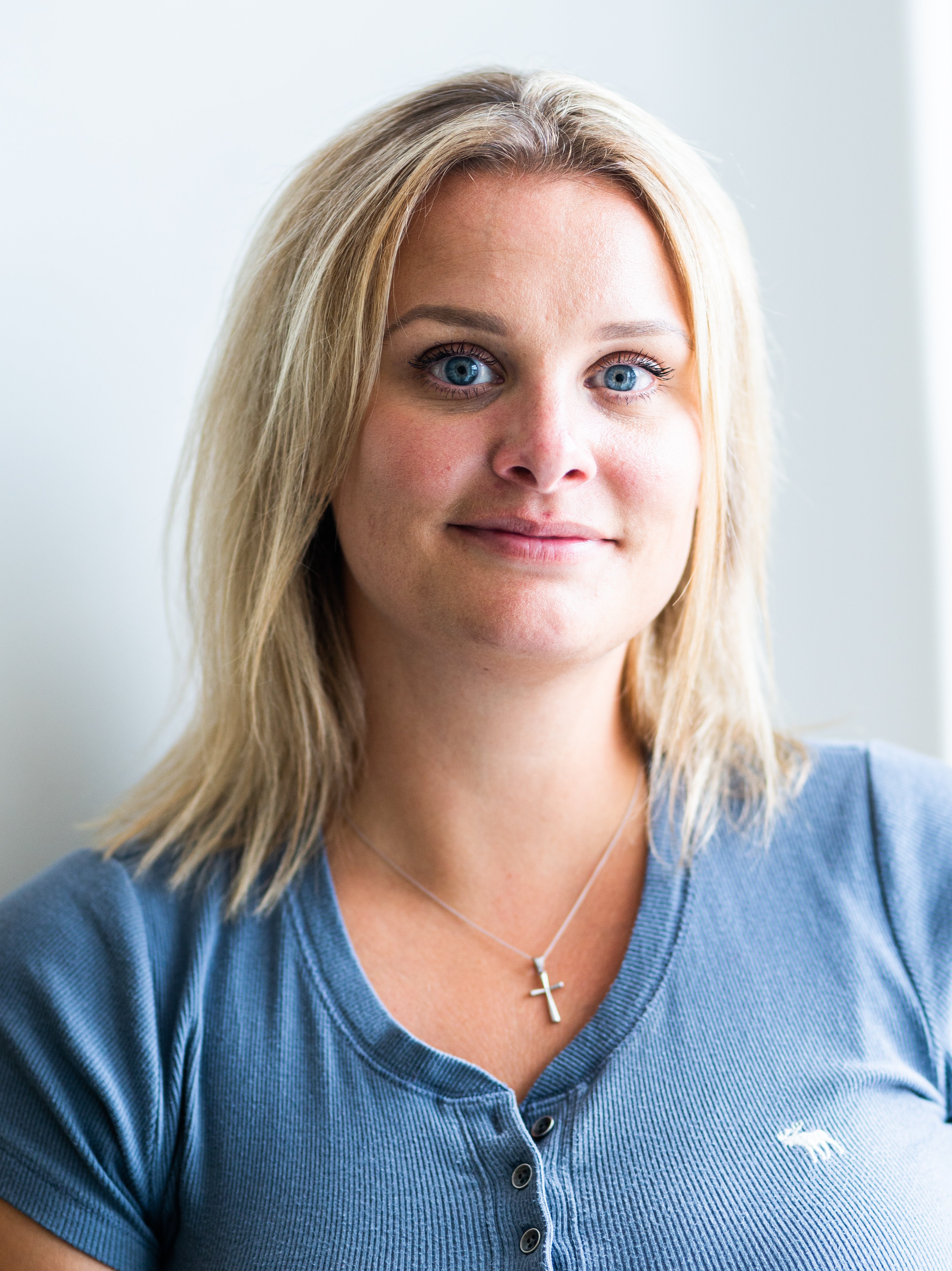 Woman in blue shirt smiling