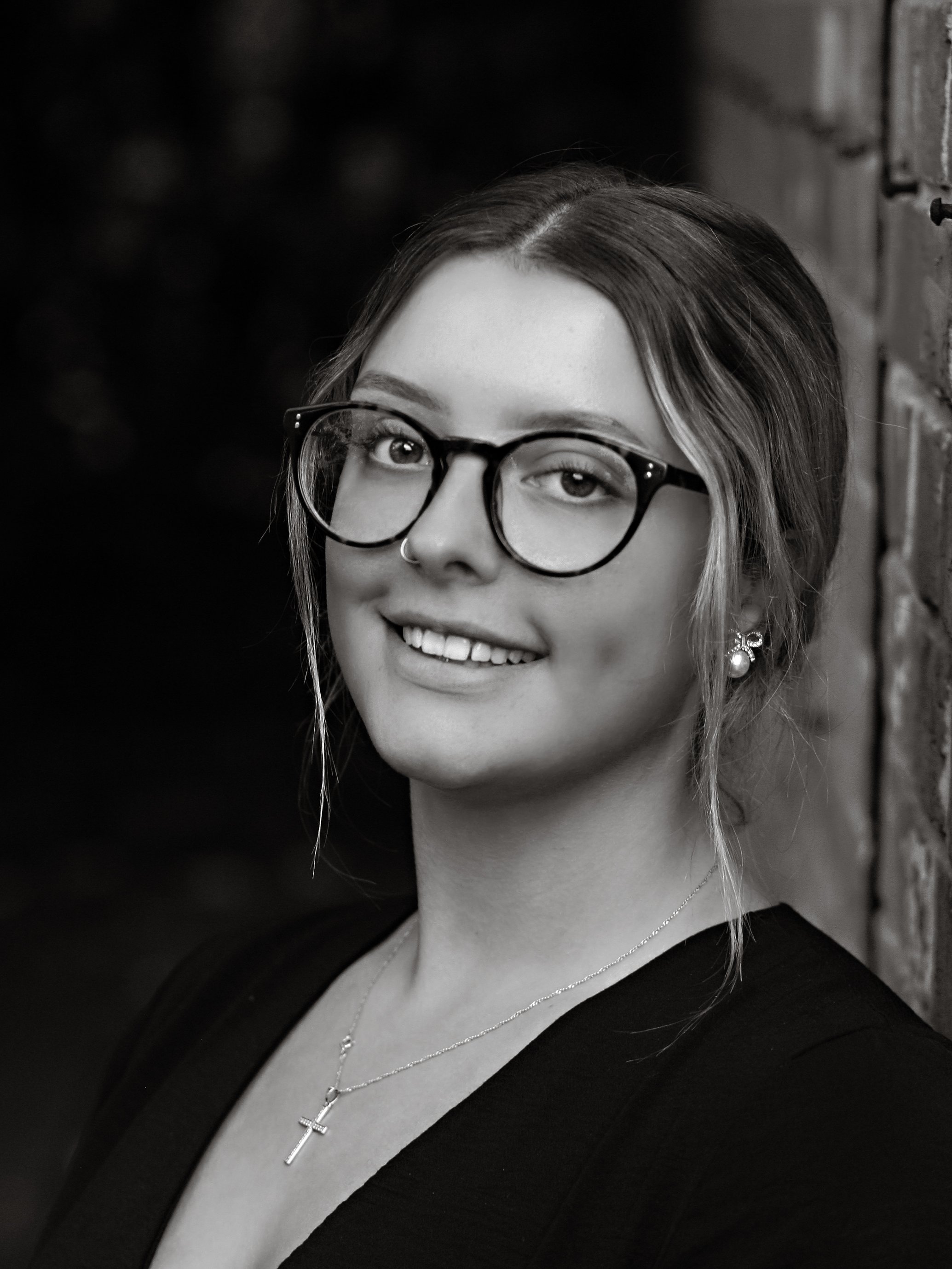 Young woman with glasses smiling