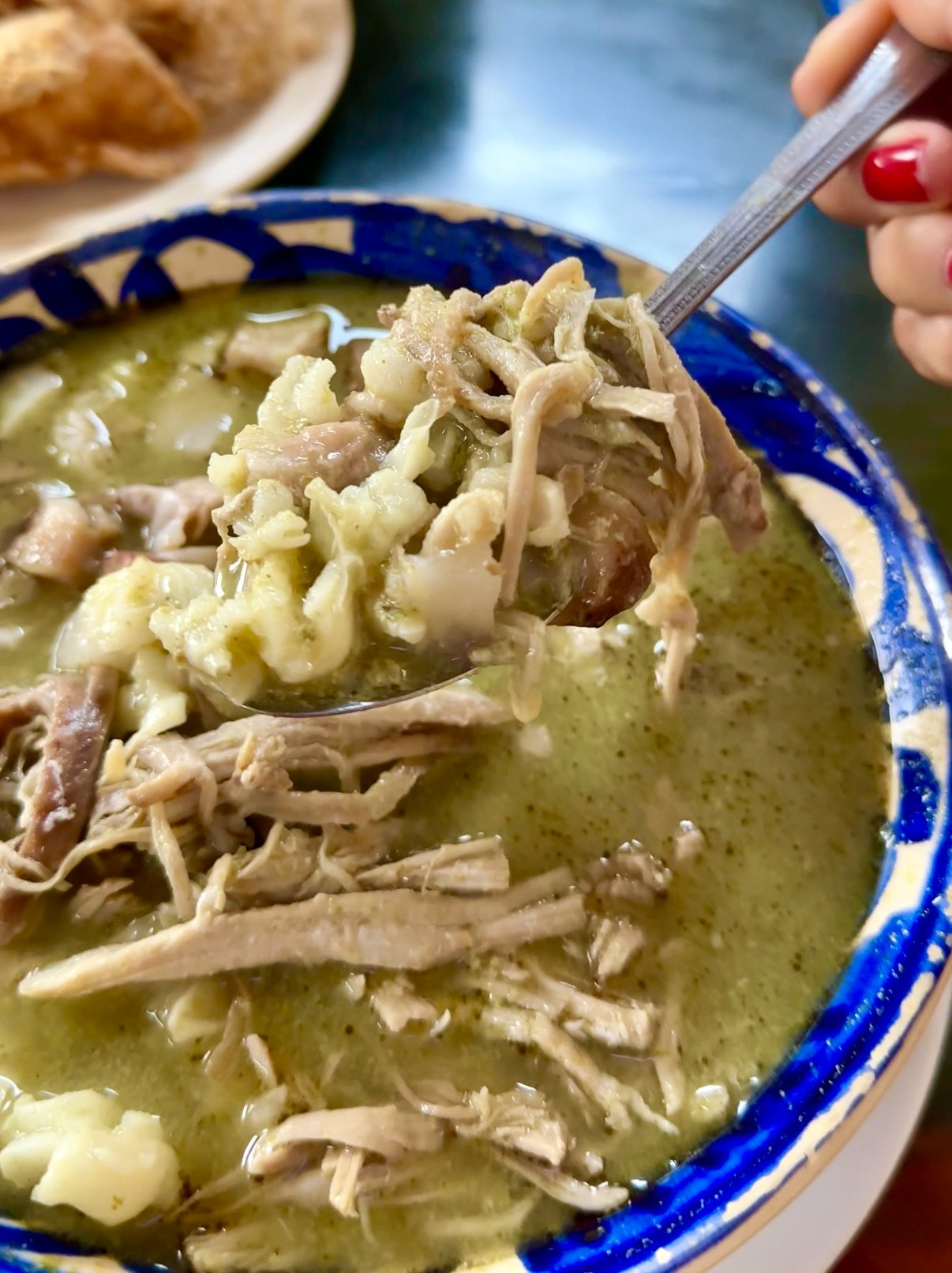 A bowl of soup in a blue bowl