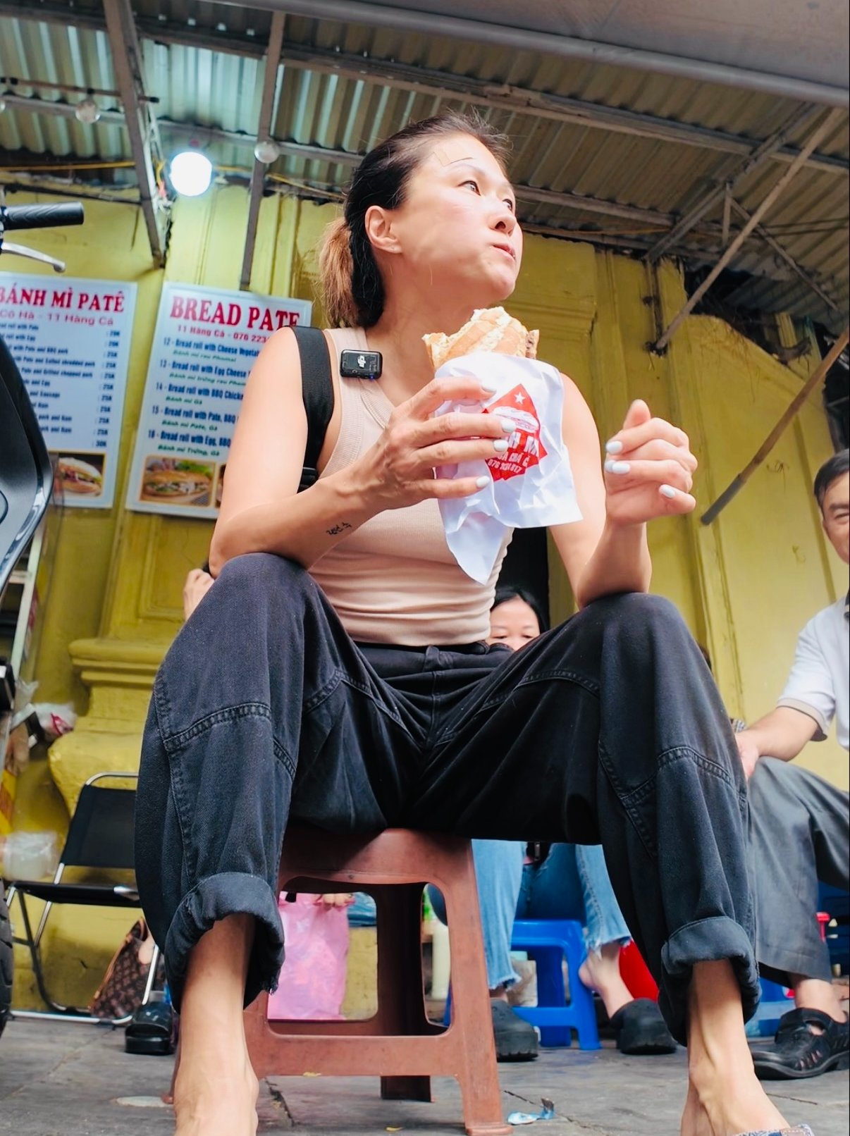 Young lady eating street food in Hanoi