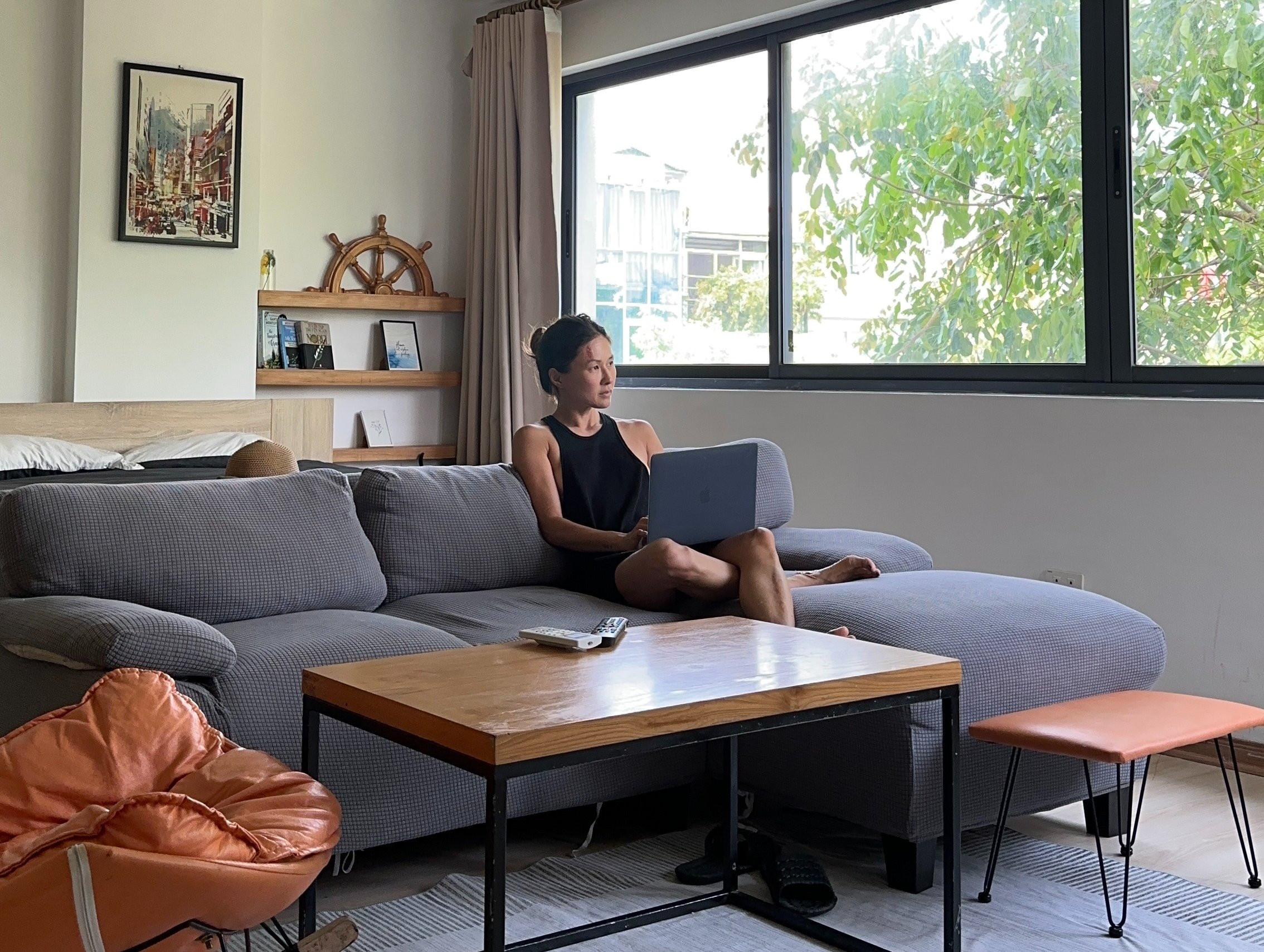 Lady reclining on sofa in mid century appartment