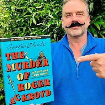 Gardening expert Simon Akeroyd sports a Hercule Poirot moustache and a copy of The Murder of Roger Ackroyd by Agatha Christie.