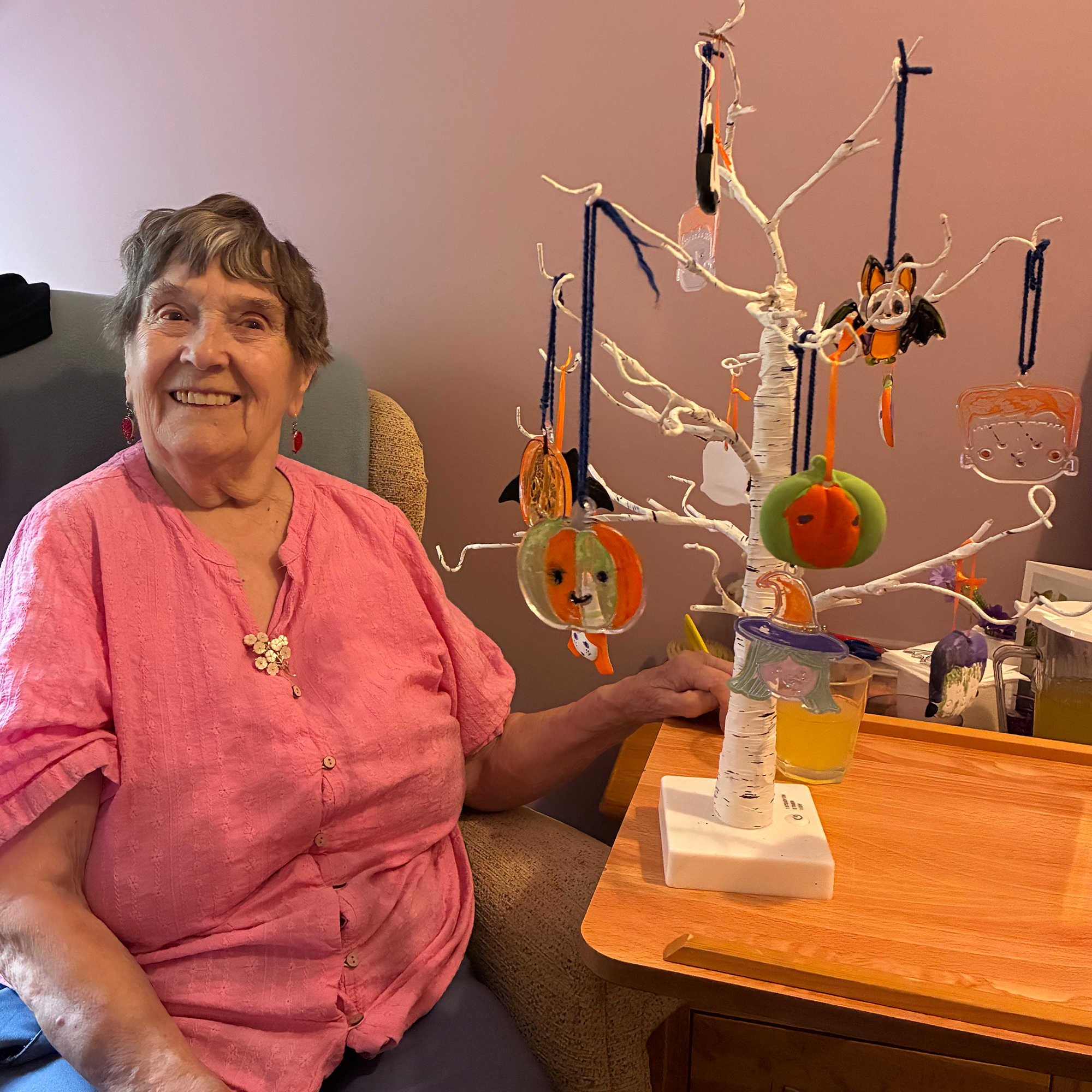 A Blackbrook House Care Home resident poses with the Halloween decorated tree she has made