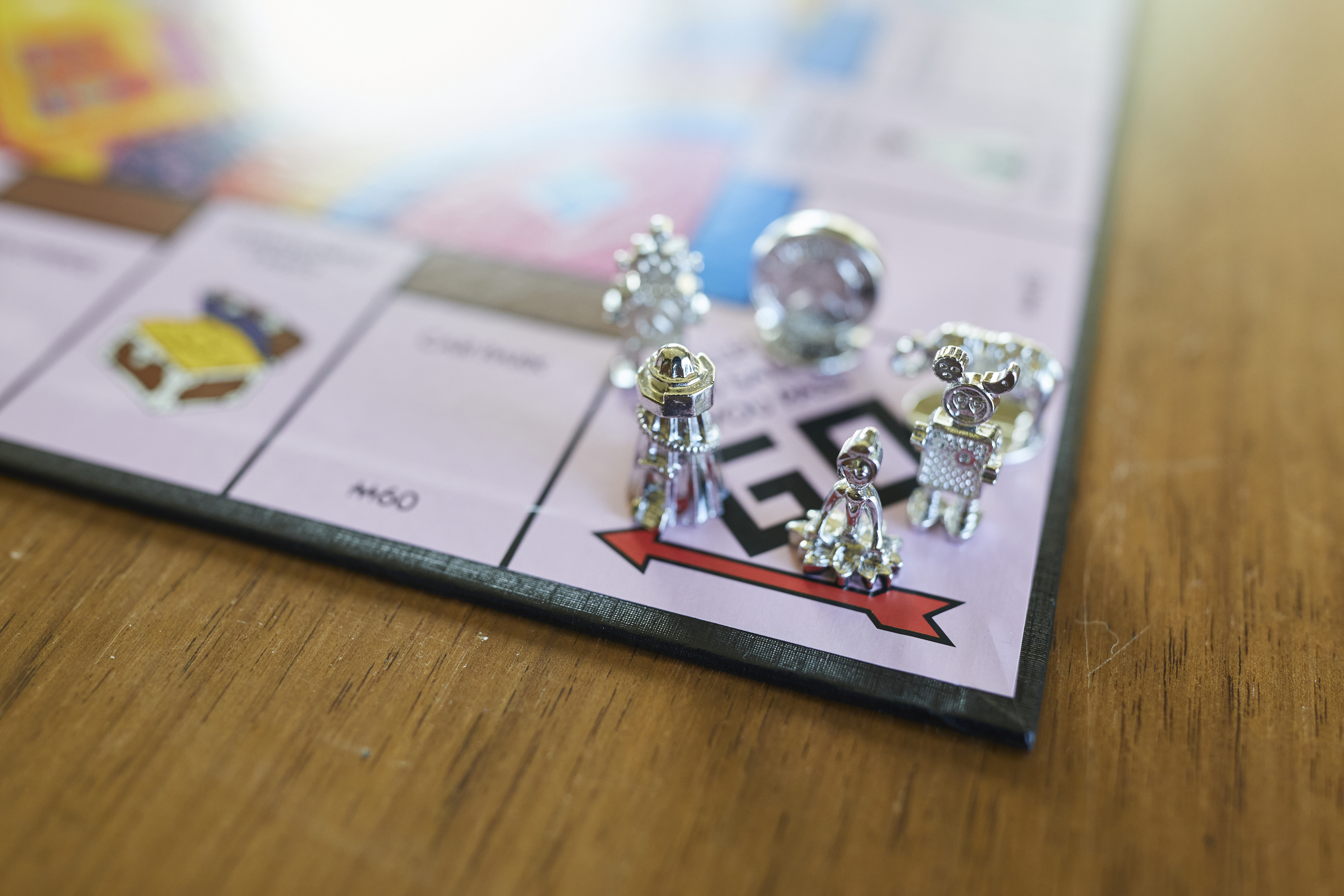 Monopoly pieces on the Monopoly Board